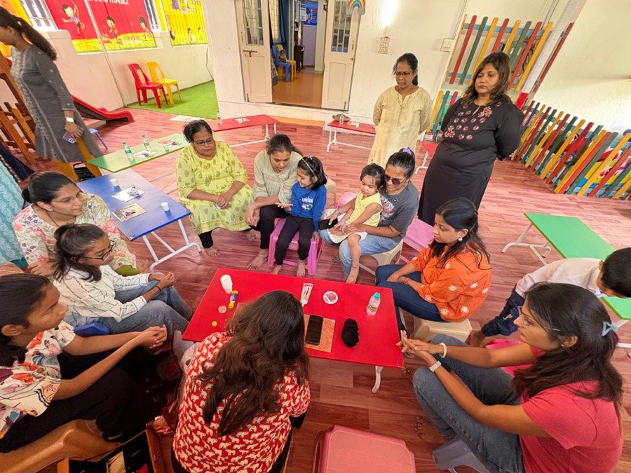A circle of families crafting together at a community workshop