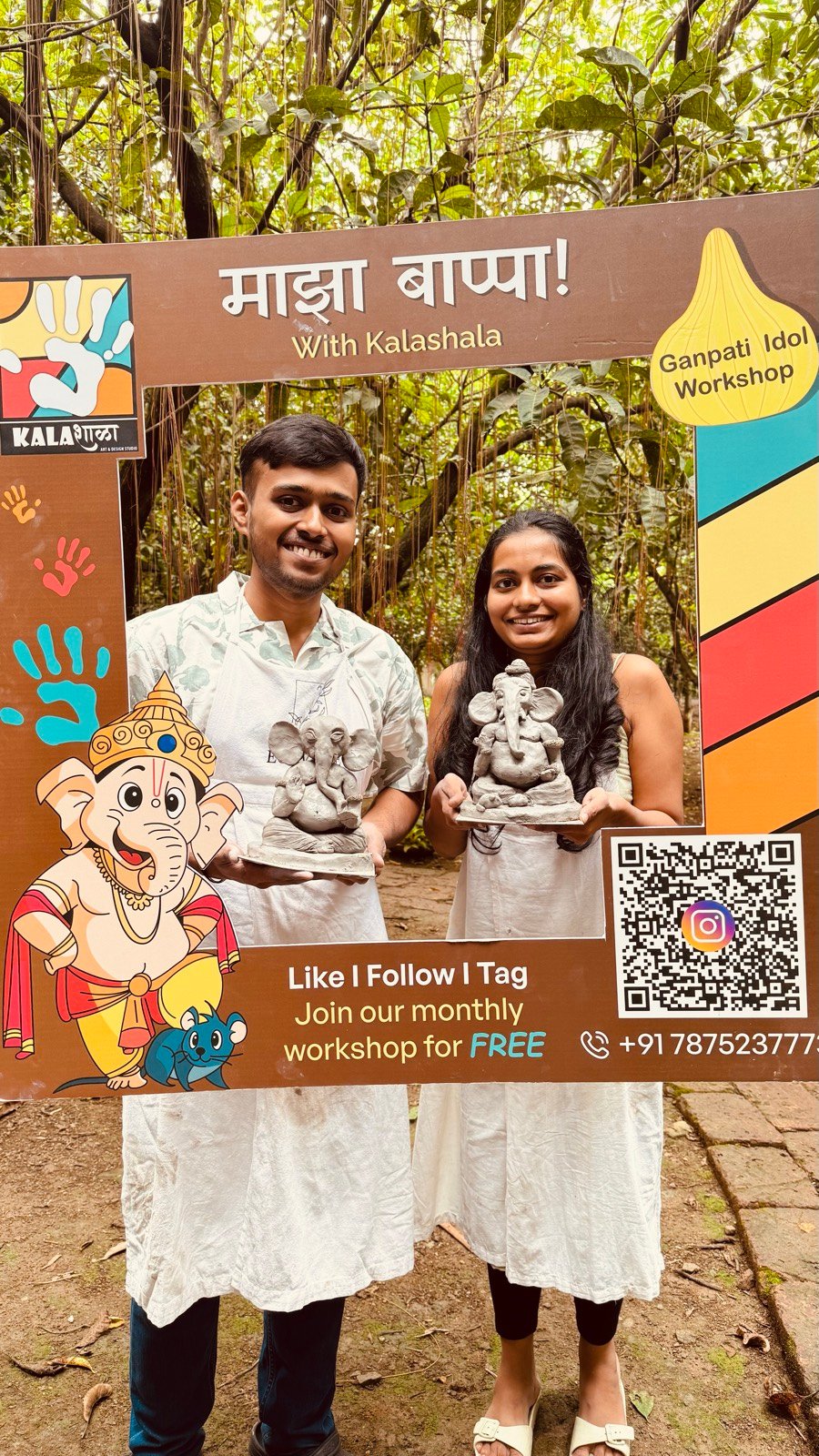 Two smiling participants holding their hand-made Ganpati idols at a Kalashala workshop